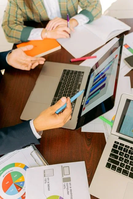 Close-up of a woman working on a digital marketing project in a home office setting.